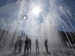 People playing in a fountain to cool off in Yangsan. 