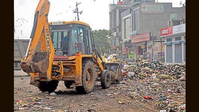 Garbage being cleared in Ludhiana on Sunday. (Gurpreet Singh/HT)