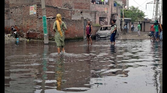 Overflowing sewage on the streets and road in bad condition in Tajour area in Ludhiana on Sunday. (Gurpreet Singh/HT)