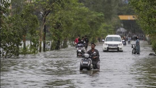 Palghar: Commuters wade through a waterlogged road after heavy rainfall, at Vasai-Virar in Palghar district, Maharashtra, Wednesday, July 8, 2026. (PTI Photo/Kunal Patil)(PTI07_08_2026_000482A) (PTI)