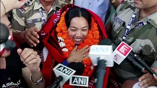 Weightlifter Mirabai Chanu is being received on arrival in New Delhi on Sunday after winning the 48kg gold at the Glasgow Commonwealth Games. (ANI)