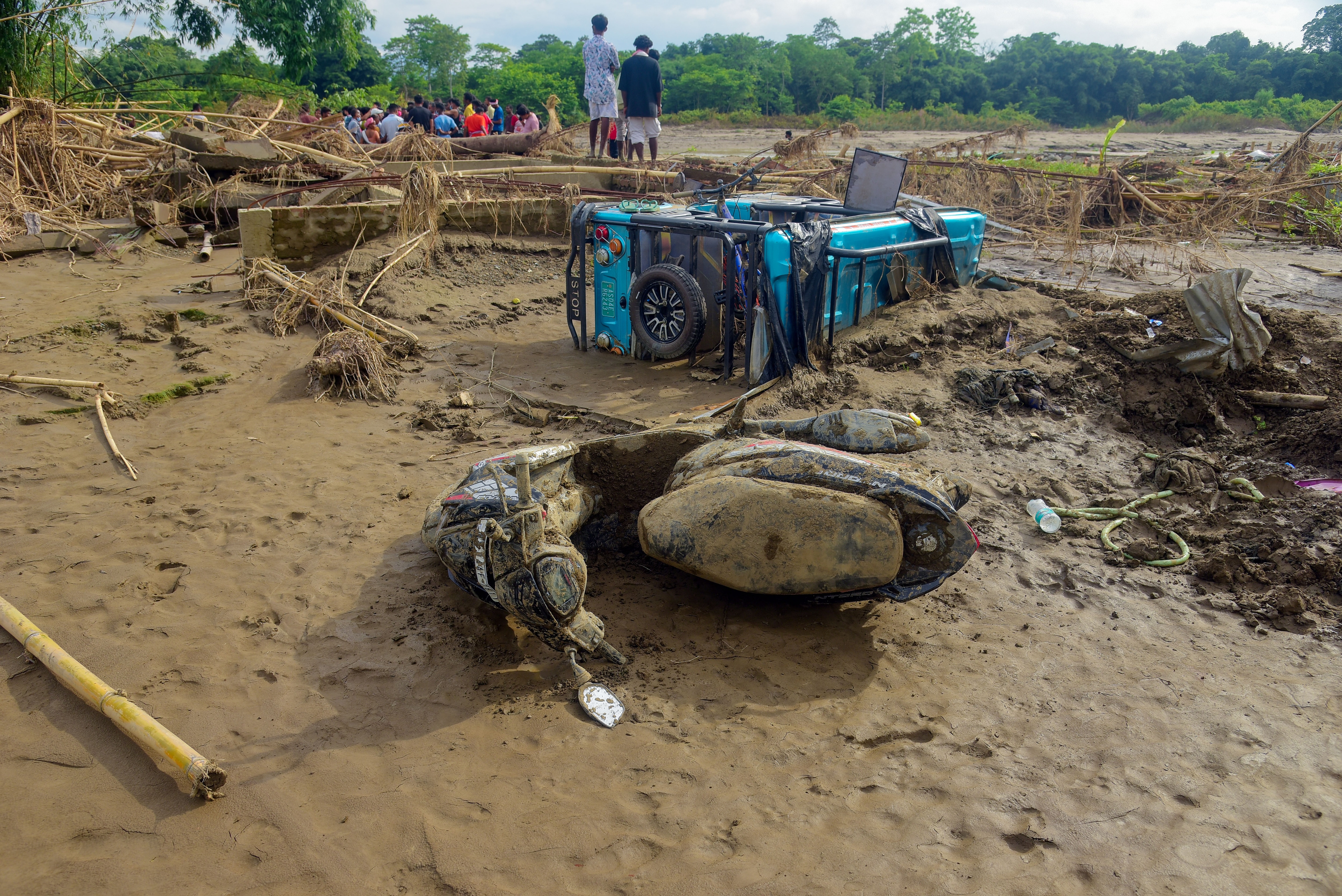 A view of damaged vehicles, which were swept away in a flash flood of the Dikhow River at Bihubar, in Sivasagar on Saturday. (File Photo/ANI) A view of damaged vehicles, which were swept away in a flash flood of the Dikhow River at Bihubar, in Sivasagar on Saturday. (File Photo/ANI)