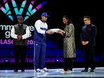 India's Neeraj Chopra, President of the Indian Olympic Association PT Usha and Gujarat deputy chief minister Harsh Sanghavi receive the flag during the closing ceremony
