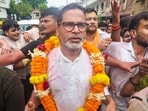 Patna: Jan Suraaj Party founder and candidate Prashant Kishor greets people during a march as he leads over BJP's Neeraj Kumar Sinha.