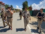 Police personnel keep vigil along the Jammu-Srinagar National Highway following a terrorist attack, in Kulgam district, Jammu and Kashmir, on Sunday. (PTI)