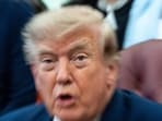 A zoom lens and slow shutter speed technique shows President Donald Trump speaking in the Oval Office of the White House, Monday, Aug. 3.