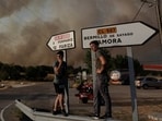 Locals watch the fire near Formariz during a wildfire in Zamora province, Spain