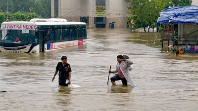 Ahmedabad: People wade through floodwater while a bus lies partially submerged following heavy monsoon rainfall, on the outskirts of Ahmedabad, Gujarat, Saturday, July 25, 2026. (PTI) Ahmedabad: People wade through floodwater while a bus lies partially submerged following heavy monsoon rainfall, on the outskirts of Ahmedabad, Gujarat, Saturday, July 25, 2026. (PTI)