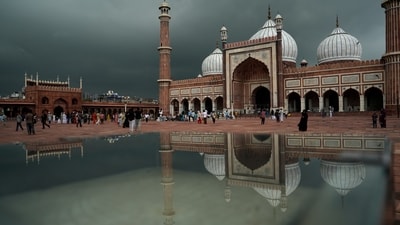 Gram it: Visitors at the Jama Masjid photographed amid heavy rainfall in Delhi. IMD has a forecast of more rains in the week ahead. (Photo: Salman Ali/PTI)