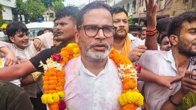 Patna: Jan Suraaj Party founder and candidate Prashant Kishor greets people during a march as he leads over BJP's Neeraj Kumar Sinha. (PTI)