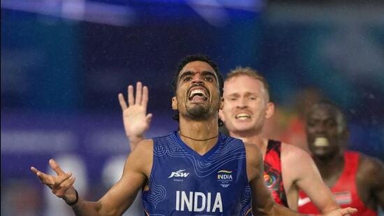 Gulveer Singh crosses the finish line to win the silver medal in the men's 10,000 meters at the Commonwealth Games in Glasgow. (AP Photo)
