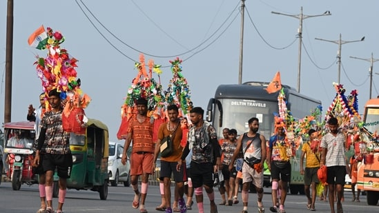 Kanwariyas, devotees of the God Shiva, carry holy water of the river Ganges during the 'Kanwar Yatra' pilgrimage in the sacred month of Sawan in New Delhi, India, on Sunday, August 2, 2026.