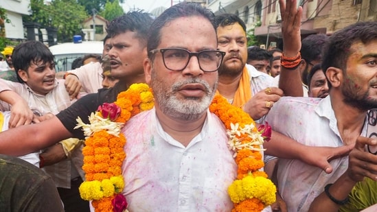 Patna: Jan Suraaj Party founder and candidate Prashant Kishor greets people during a march as he leads over BJP's Neeraj Kumar Sinha.