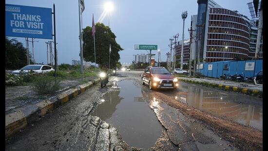 Potholes on a road in Gomti Nagar Extension-7 in Lucknow. (Deepak Gupta/HT Photo)