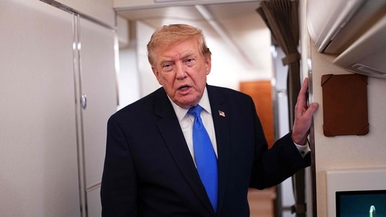 US President Donald Trump speaks to the press aboard Air Force One