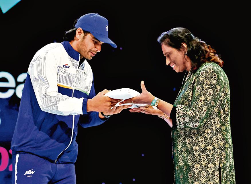 Neeraj Chopra passing on the CWG flag to Indian Olympic Association president PT Usha as India will host the 2030 edition.