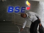 A man touches the stairs as he arrives at the Bombay Stock Exchange (BSE) building in Mumbai.