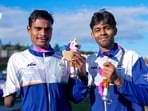 India's Dilip Mahadu Gavit, left, gold medallist, and Mohammed Basil, silver medallist, pose with their medals after the Men's 100m T47 para-athletics event
