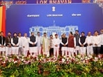 Karnataka Chief Minister DK Shivakumar and Governor Thawar Chand Gehlot pose with newly inducted ministers and other leaders. (@DKShivakumar/X via PTI Photo)(PTI08_03_2026_000499B)