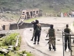 Security personnel stand guard near a damaged bridge after a cloudburst triggered flash floods in the Batkoot area of Pahalgam, in Anantnag district on Monday. (PTI)
