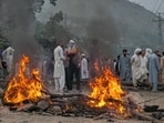 Supporters of an outlawed alliance of activist groups "Joint Awami Action Committee" (JAAC) block a road and set on fire woods after clashes with police during protest demanding greater political rights and the abolition of 12 legislative refugee seats, in Muzaffarabad, the capital of Pakistan-occupied Kashmir, on July 31 (AP File Photo/Ishfaq Hussain)
