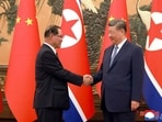 Chinese President Xi Jinping shakes hands with North Korean Premier Pak Thae Song in Beijing.