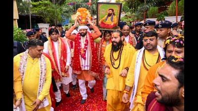 Haryana Chief Minister Nayab Singh Saini carries the sacred kalash containing soil from the birthplace of Guru Ravidas during the Kalash Vandan Yatra, in Gurugram, on Tuesday. (PTI) Haryana Chief Minister Nayab Singh Saini carries the sacred kalash containing soil from the birthplace of Guru Ravidas during the Kalash Vandan Yatra, in Gurugram, on Tuesday. (PTI)
