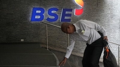 A man touches the stairs as he arrives at the Bombay Stock Exchange (BSE) building in Mumbai. (Reuters File)