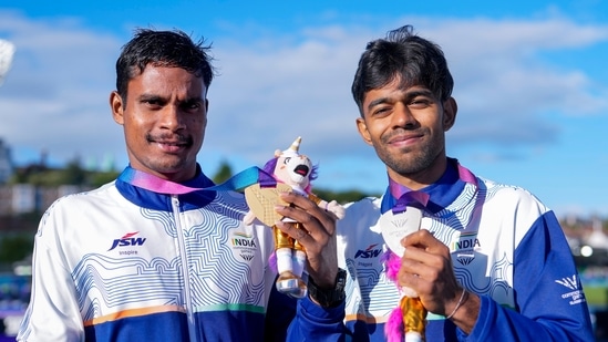 India's Dilip Mahadu Gavit, left, gold medallist, and Mohammed Basil, silver medallist, pose with their medals after the Men's 100m T47 para-athletics event