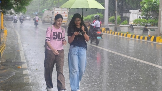 Gram it: As monsoon showers soak Delhi, giving the city a much-needed respite from heat and humidity, here's how some college students were spotted taking shade under umbrella while they walked back home from Delhi University's North Campus, on Tuesday. Delhiites, brace yourselves for more rain as the India Meteorological Department (IMD) has a forecast of light to moderate rainfall for today as well.(Photo: RAJ K RAJ/Hindustan Times)