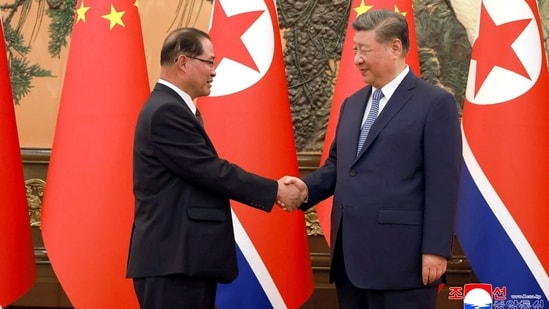 Chinese President Xi Jinping shakes hands with North Korean Premier Pak Thae Song in Beijing.