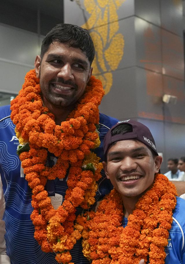 Boxing silver medallists Jadumani Singh Mandengbam (R), and Narender (L) were welcomed with several flower garlands upon their arrival. (Photo: Atul Yadav/PTI) Boxing silver medallists Jadumani Singh Mandengbam (R), and Narender (L) were welcomed with several flower garlands upon their arrival. (Photo: Atul Yadav/PTI)