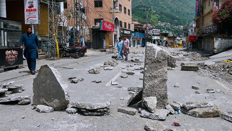 A road blocked with pieces of concrete set up by supporters of the outlawed JAAC during a protest demanding greater political rights and the abolition of 12 legislative refugee seats in Muzaffarabad, the capital of Pakistan-occupied Kashmir, on Aug. 1 (AP) A road blocked with pieces of concrete set up by supporters of the outlawed JAAC during a protest demanding greater political rights and the abolition of 12 legislative refugee seats in Muzaffarabad, the capital of Pakistan-occupied Kashmir, on Aug. 1 (AP)