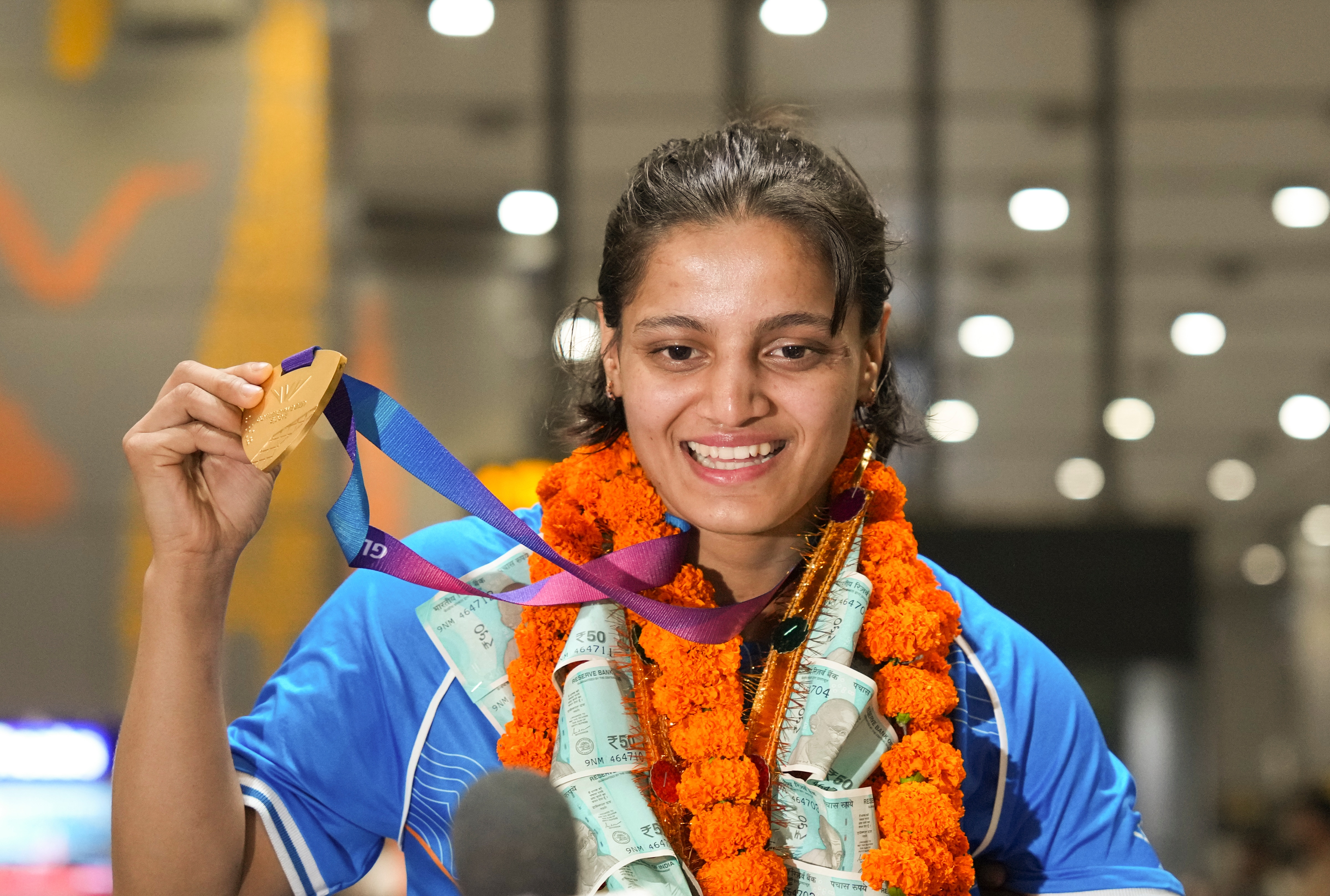 Judo gold medallist Asmita Dey poses as she wore her triumph on her sleeve upon her arrival after the Glasgow Commonwealth Games, at IGI Airport in New Delhi on Tuesday August 4, 2026. (Photo: Atul Yadav/PTI) Judo gold medallist Asmita Dey poses as she wore her triumph on her sleeve upon her arrival after the Glasgow Commonwealth Games, at IGI Airport in New Delhi on Tuesday August 4, 2026. (Photo: Atul Yadav/PTI)