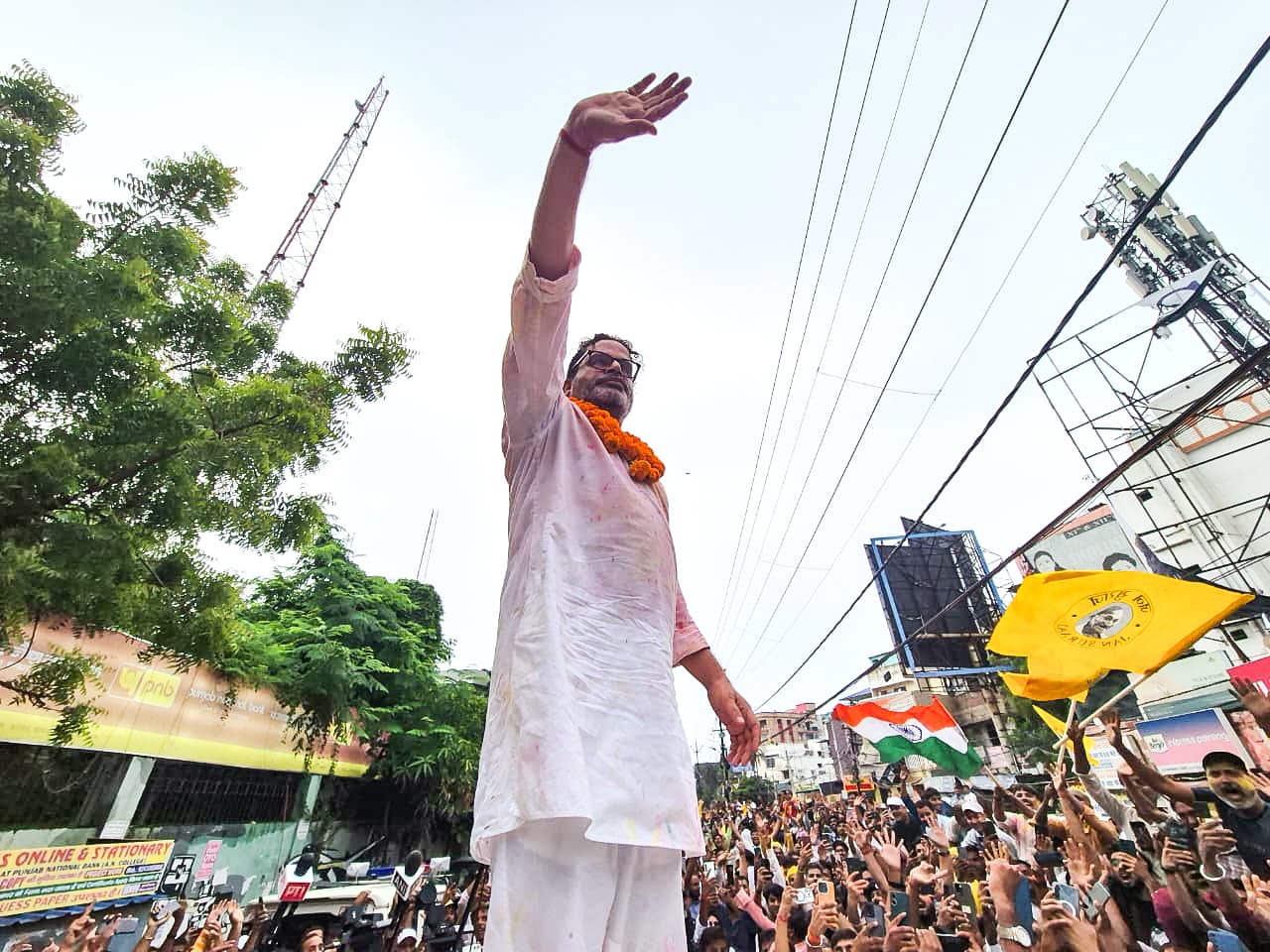 Jan Suraaj Party (JSP) founder Prashant Kishor waves at party workers during a victory march as he takes the lead in the Bankipur assembly bypoll result, in Patna on Monday. (@jansuraajonline X)