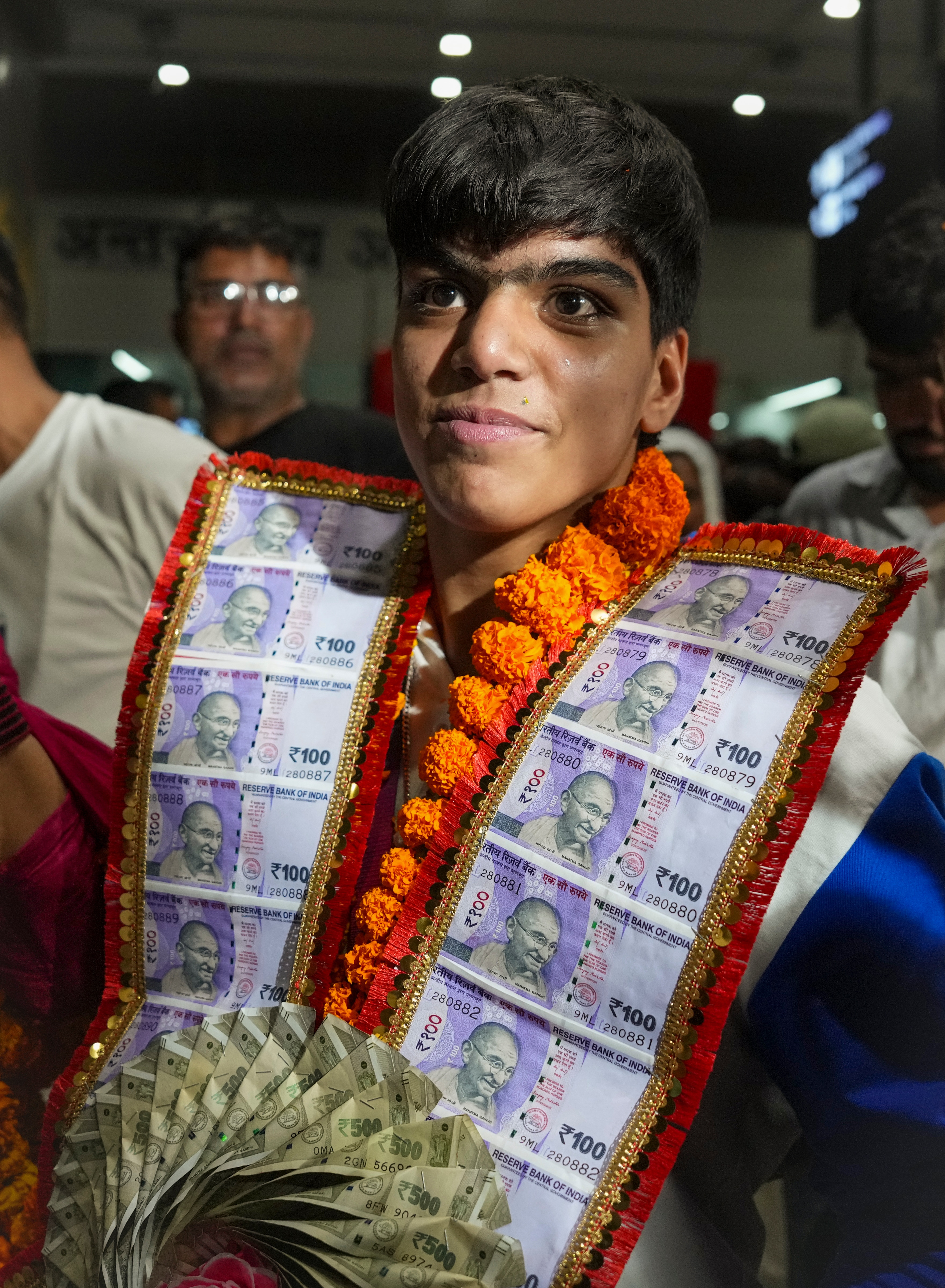 Boxing gold medallist Priya Ghanghas was welcomed with equal warmth at IGI Airport, and her garland of Indian currency notes caught all the praiseworthy views. (Photo: Atul Yadav/PTI) Boxing gold medallist Priya Ghanghas was welcomed with equal warmth at IGI Airport, and her garland of Indian currency notes caught all the praiseworthy views. (Photo: Atul Yadav/PTI)