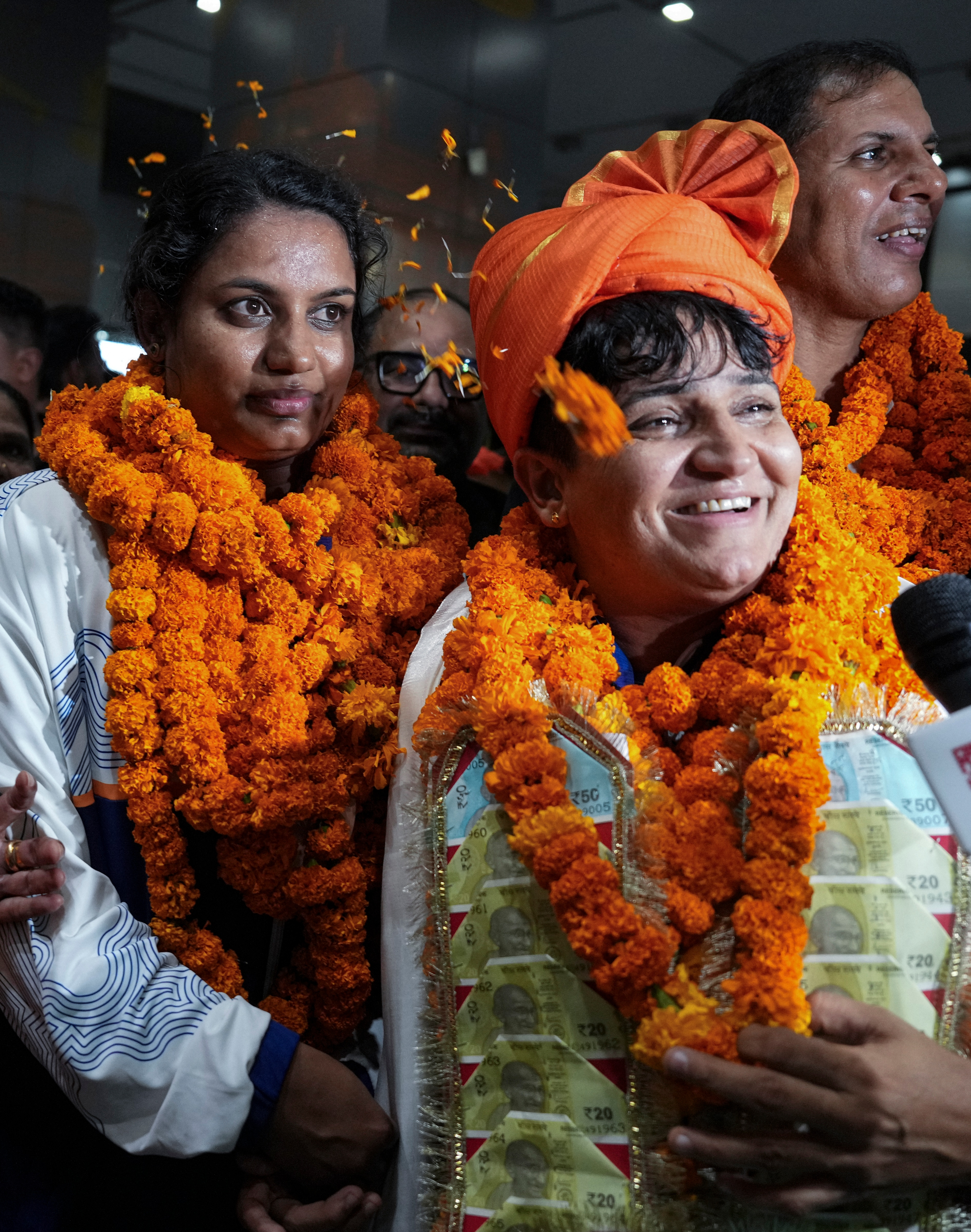 Para-athlete gold medallist Sharmila Dhankhar (R) and bronze medallist Shilpa K Shyla were awestruck with the love and warmth they received upon landing in India after the recent CWG Games. The two won their respective medals in women’s F57 shot-put category. (Photo: PTI) Para-athlete gold medallist Sharmila Dhankhar (R) and bronze medallist Shilpa K Shyla were awestruck with the love and warmth they received upon landing in India after the recent CWG Games. The two won their respective medals in women’s F57 shot-put category. (Photo: PTI)