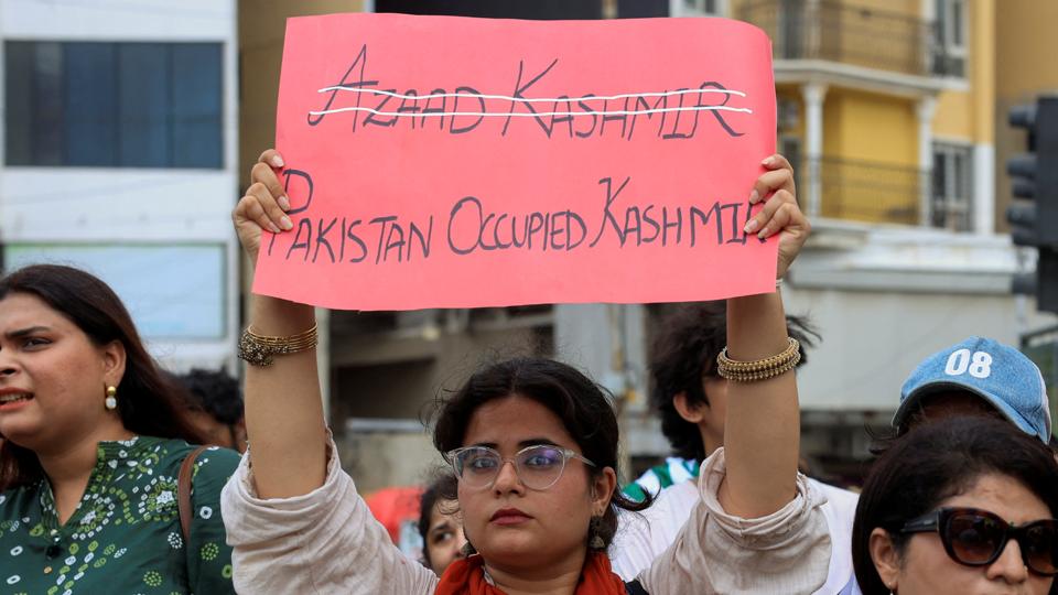 A woman holds a placard as people gather in support of the banned JAAC, an alliance of civil society groups in Pakistan-occupied Kashmir, during a demonstration in Karachi, August 1 (REUTERS) A woman holds a placard as people gather in support of the banned JAAC, an alliance of civil society groups in Pakistan-occupied Kashmir, during a demonstration in Karachi, August 1 (REUTERS)