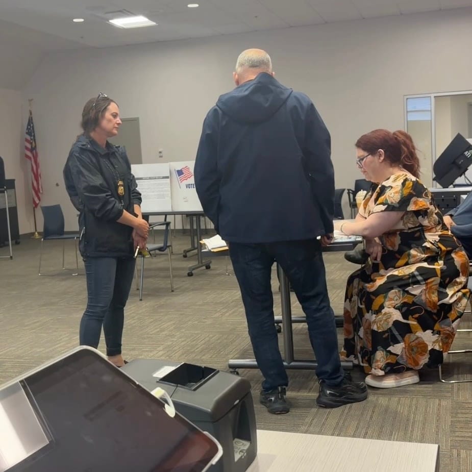 A screenshot from a handout video of two agents from ICE OPR arriving at the voting site where Gonyea was working to warn her about a social-media post. A screenshot from a handout video of two agents from ICE OPR arriving at the voting site where Gonyea was working to warn her about a social-media post.