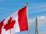 A Canadian flag flies near the Gordie Howe bridge connecting Windsor, Ontario, Canada, with Detroit, Michigan, US. (REUTERS)