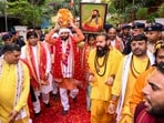 Haryana Chief Minister Nayab Singh Saini carries the sacred kalash containing soil from the birthplace of Guru Ravidas during the Kalash Vandan Yatra, in Gurugram, on Tuesday. (PTI)