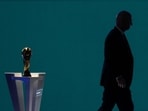 Fifa president Gianni Infantino is silhouetted as he walks past the world cup trophy after addressing the Fifa Congress in Vancouver, British Columbia.(AP File)