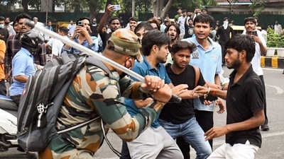 A security official carries out Lathi charge on protestors during their protest march towards Parliament called by Cockroach Janta Party, near Jantar Mantar in New Delhi. (ANI) A security official carries out Lathi charge on protestors during their protest march towards Parliament called by Cockroach Janta Party, near Jantar Mantar in New Delhi. (ANI)