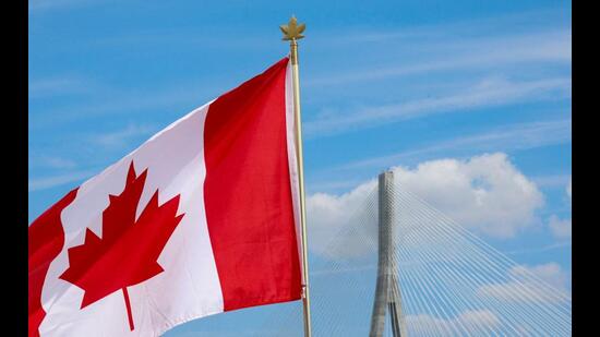A Canadian flag flies near the Gordie Howe bridge connecting Windsor, Ontario, Canada, with Detroit, Michigan, US. (REUTERS)