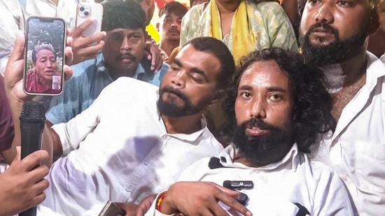 Environmentalist Sonam Wangchuk interacts with student leader Devendra Nath Mahato, who continues his hunger strike to protest against alleged irregularities in the JPSC, JJSC and various other competitive exams at Jaipal Singh Munda Stadium, in Ranchi on Wednesday.