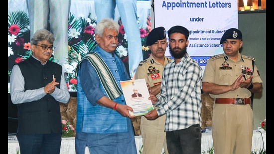 Jammu and Kashmir lieutenant governor Manoj Sinha hands over appointment letters for government jobs to the family members of terror victims at SKICC, in Srinagar on Wednesday. (ANI)