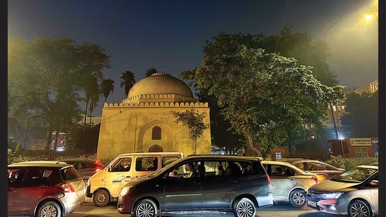 The pale walls were catching just enough light from two street lamps to remind the passing commuters that Gol Gumbad was still there.