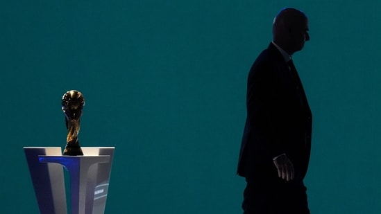 Fifa president Gianni Infantino is silhouetted as he walks past the world cup trophy after addressing the Fifa Congress in Vancouver, British Columbia.(AP File)