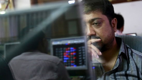 File photo: A broker reacts while trading at his computer terminal at a stock brokerage firm in Mumbai