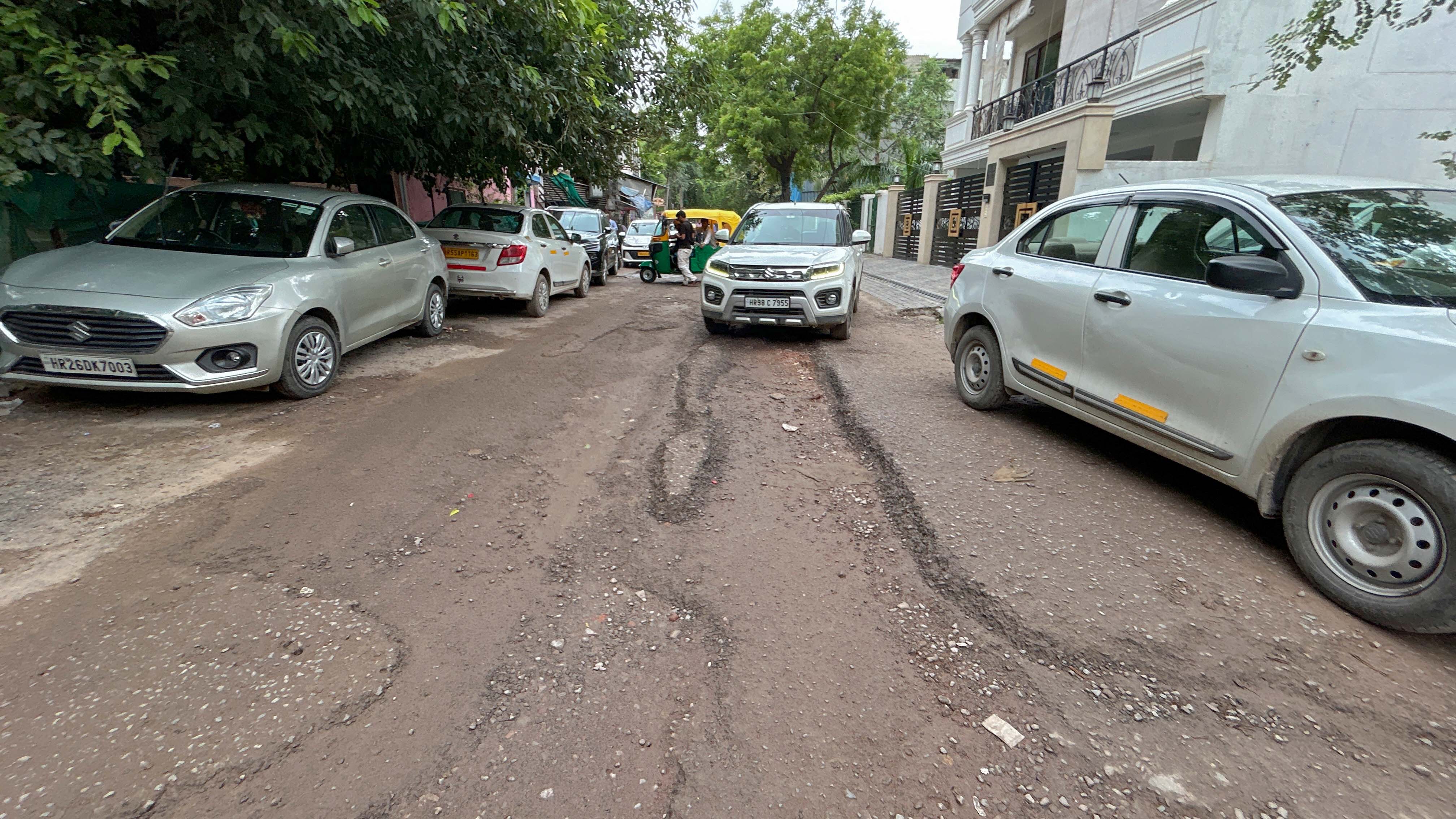 A cratered internal road in Block A on Tuesday (Parveen Kumar/HT)